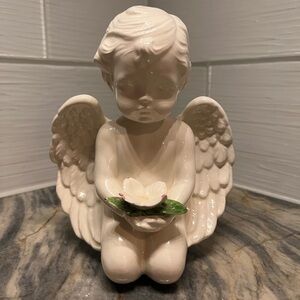 Ceramic Angel Cherub With Flower 
Approx 6.5” tall